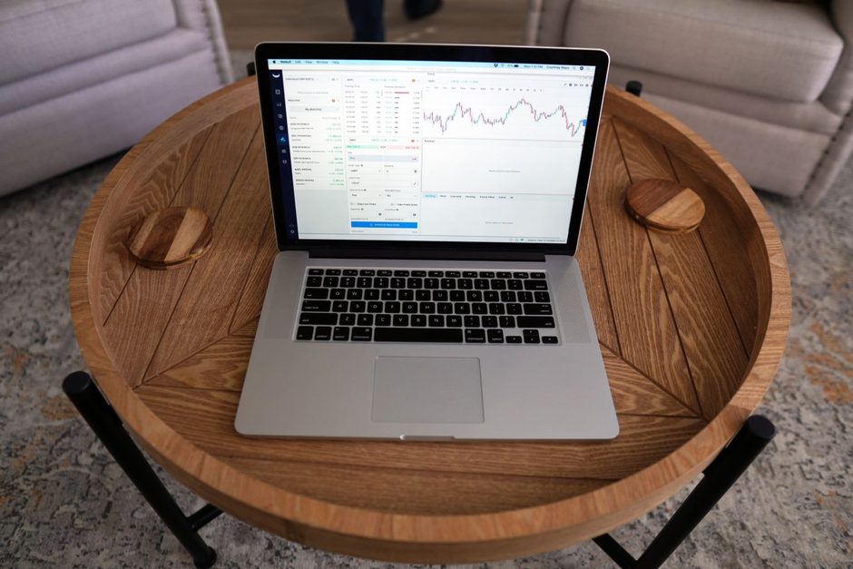 Laptop on a round wooden tray showing an analytics dashboard. Photo by Joshua Mayo on Pexels