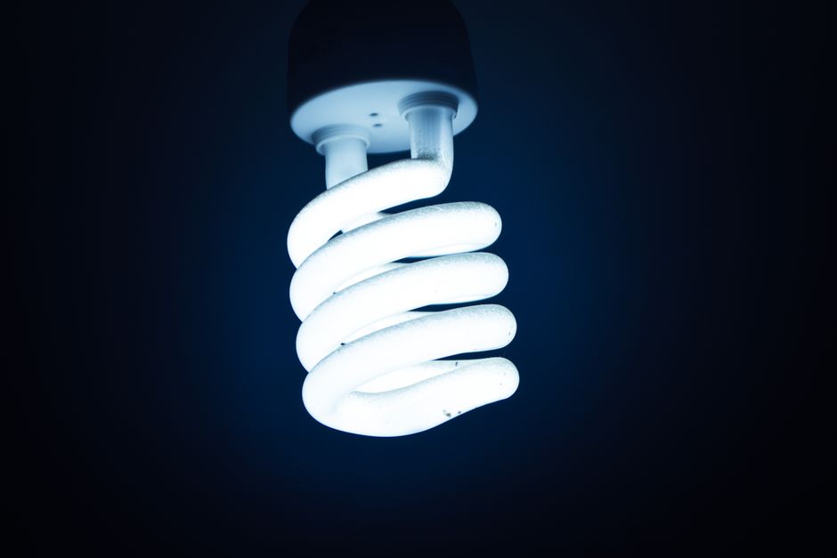 Close-up of a glowing spiral energy-saving bulb against a dark backdrop, emphasizing sustainable energy. Photo by Zain Ali on Pexels