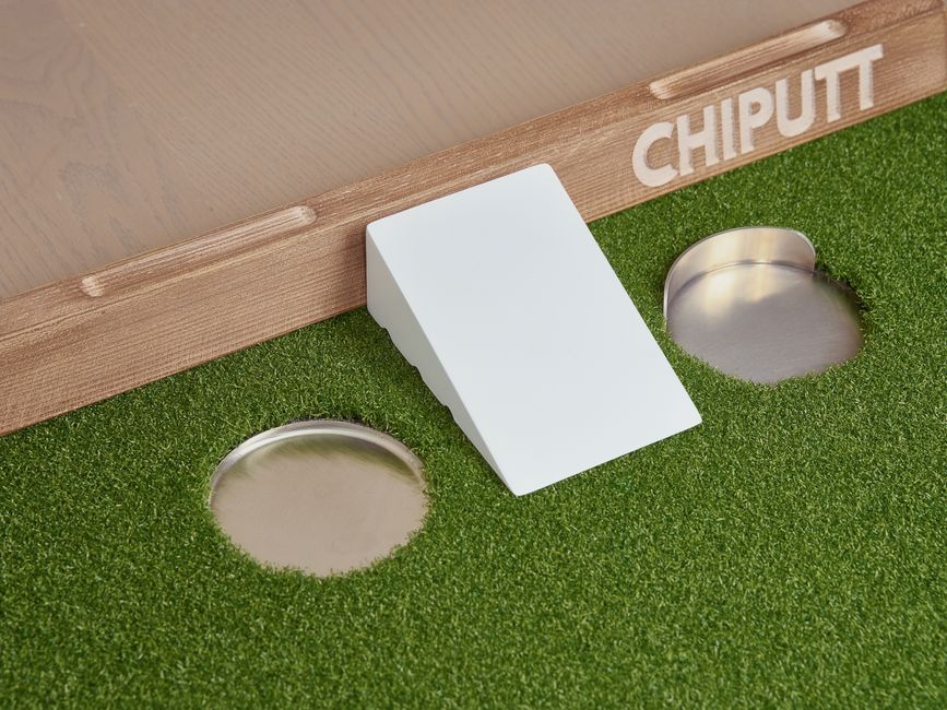 Enhance your golf skills with this innovative chip and putt training aid featuring artificial turf and multiple practice holes. Photo by Chiputt Golf on Pexels