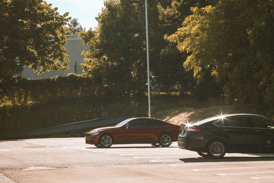 Photo by Eathan Hood on Pexels Cars parked under sunlit trees in an outdoor parking lot with lens flare. Photo by Eathan Hood on Pexels