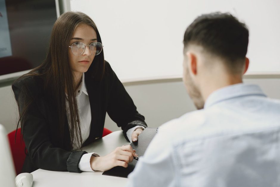 Photo by Gustavo Fring on Pexels Bank advisor talking with a client across a desk in a bright office. Photo by Gustavo Fring on Pexels