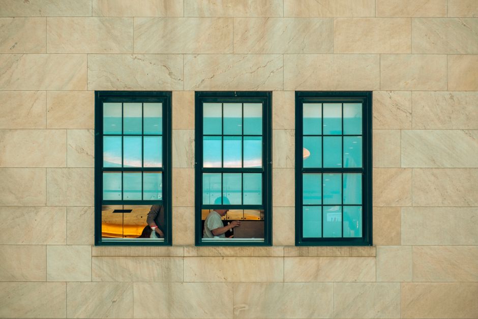 Photo by _ Whittington on Pexels Symmetrical window view showing city life inside a New York building facade. Photo by _ Whittington on Pexels