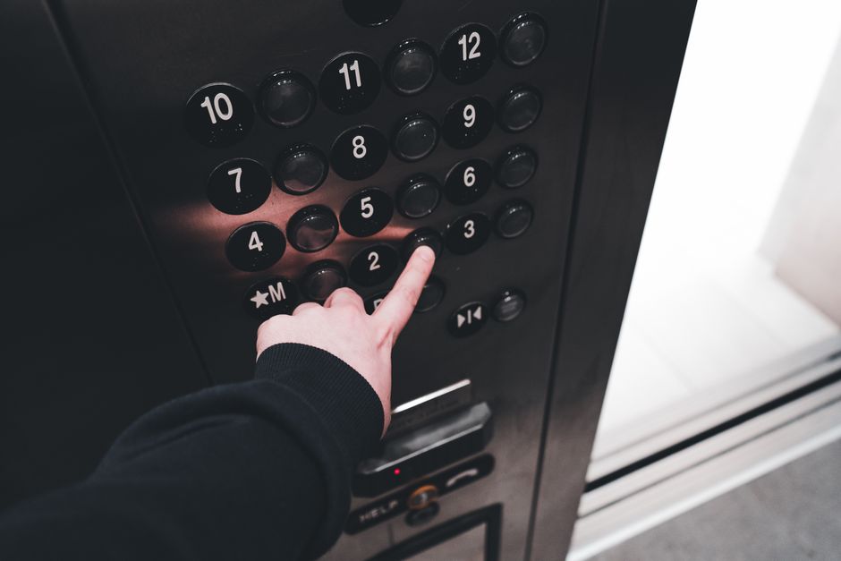 Photo by Erik Mclean on Pexels A person pressing the elevator button inside a modern elevator, showcasing the control panel with floor numbers. Photo by Erik Mclean on Pexels