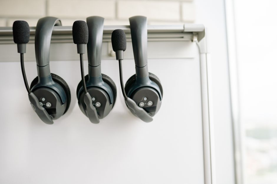 Photo by Yan Krukau on Pexels Three black headsets neatly organized on a whiteboard hook, emphasizing tech and communication. Photo by Yan Krukau on Pexels