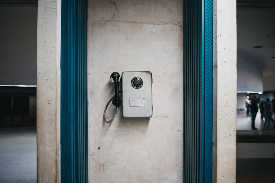 Photo by Lisett Kruusimäe on Pexels A vintage rotary dial telephone mounted on a wall, showcasing urban architecture. Photo by Lisett Kruusimäe on Pexels