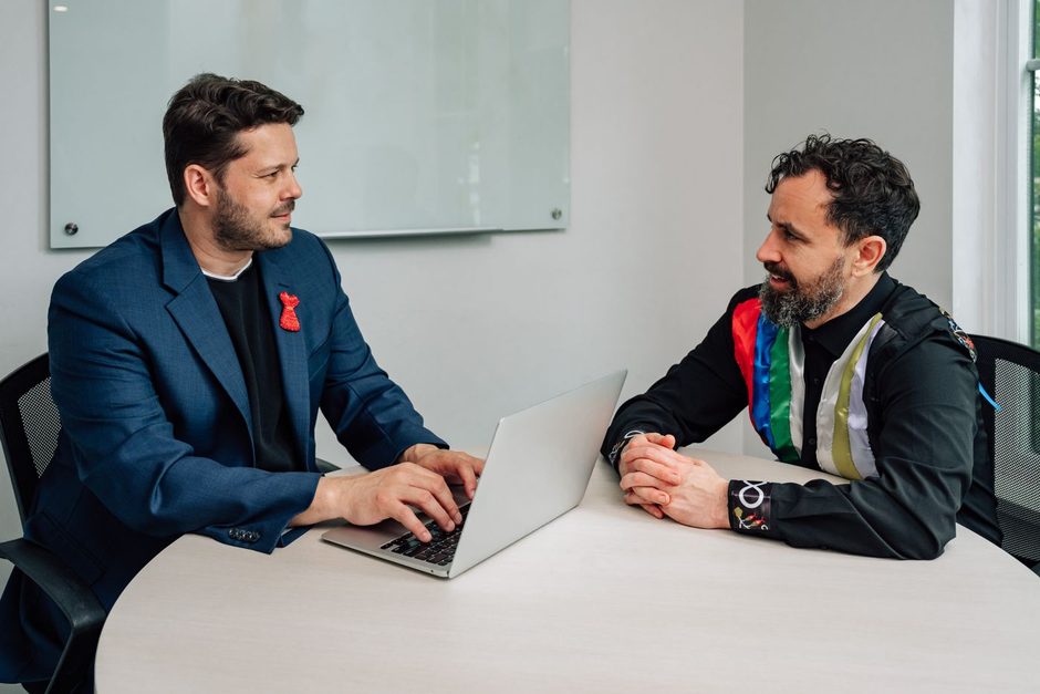 Photo by Jelly Marketing on Pexels Two business professionals meeting at a table with a laptop in a bright office. Photo by Jelly Marketing on Pexels
