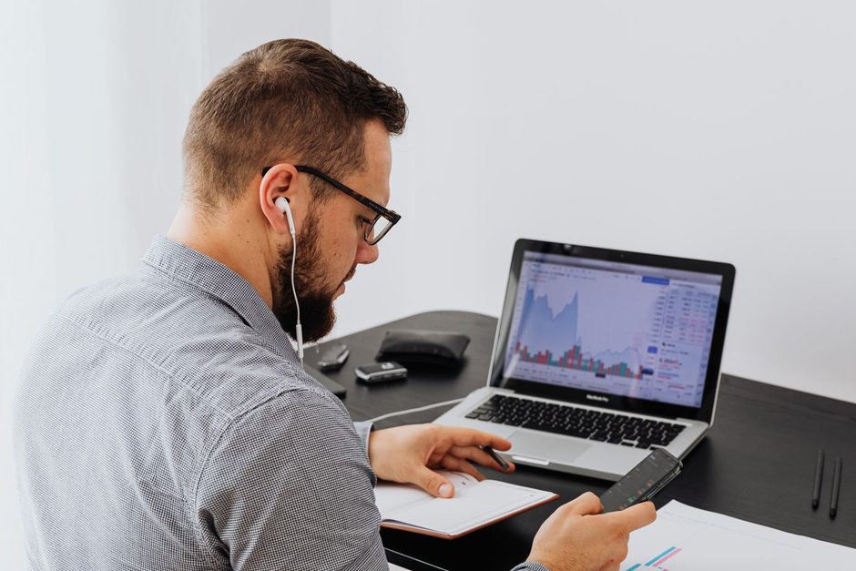 Analyst working on a laptop with data charts at a bright office desk. Photo by https://kaboompics.com/ on Pexels