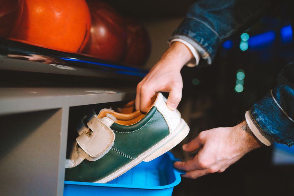 Photo by Anastasia Shuraeva on Pexels Close-up of hands handling bowling shoes with bowling balls in the background. Photo by Anastasia Shuraeva on Pexels