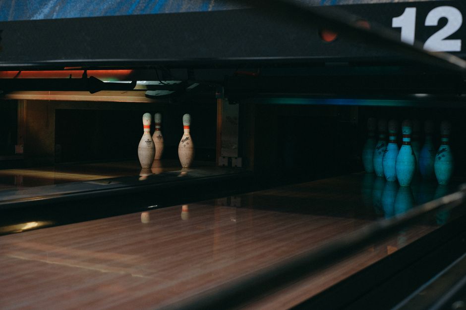 Photo by Anna Shvets on Pexels A dimly lit bowling alley showcasing lined-up pins ready for a strike. Photo by Anna Shvets on Pexels