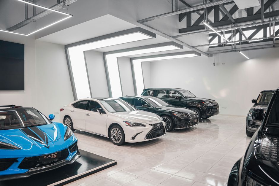 Sleek luxury cars showcased in a stylish, modern automotive dealership. Photo by Dextar Studio ™ on Pexels