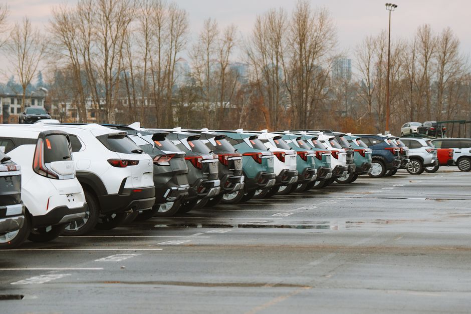 A line of parked cars in an outdoor urban parking lot on a cloudy day. Photo by Luke Miller on Pexels