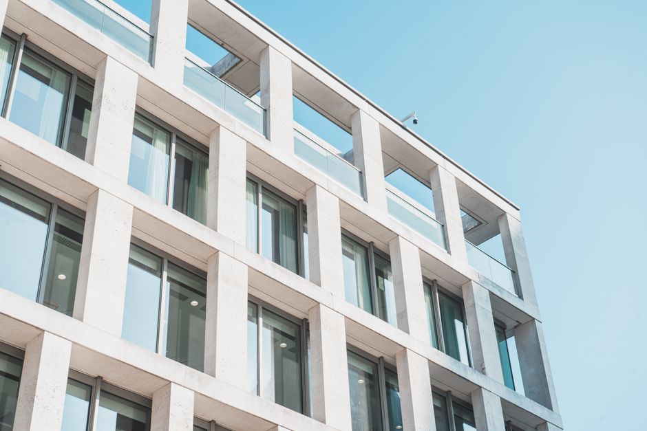 Contemporary office building with glass and concrete design, viewed from a low angle against the sky. Photo by Dylan Bueltel on Pexels
