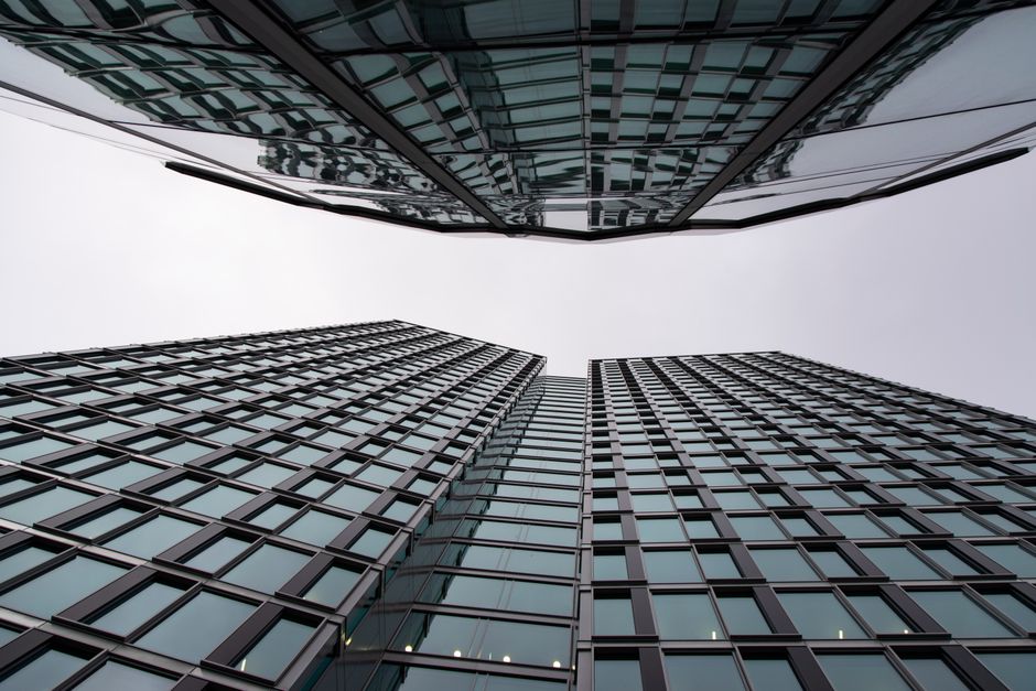 Dynamic view of mirrored skyscrapers in Warsaw's financial district, showcasing modern architecture. Photo by Nadzeya Klim on Pexels