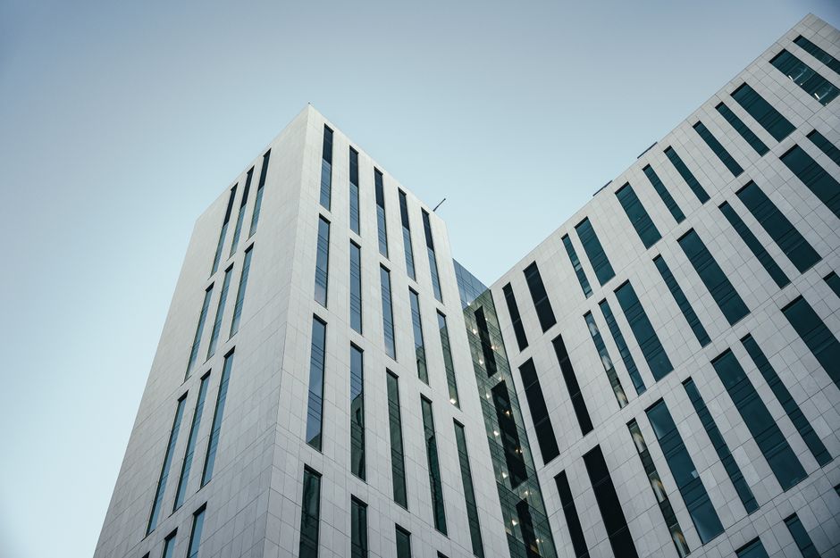 Photo by Brett Sayles on Pexels From below of contemporary multistory building with futuristic design and windows with unusual shapes located against cloudless blue sky on street of city. Photo by Brett Sayles on Pexels
