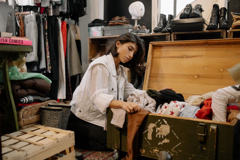 Photo by cottonbro studio on Pexels Young woman browsing vintage garments in a cozy thrift shop setting. Photo by cottonbro studio on Pexels