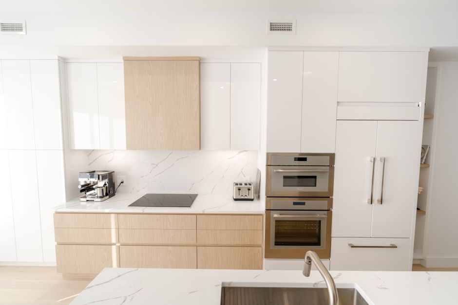 A sleek and modern kitchen with built-in appliances and marble countertops, offering a bright and clean aesthetic. Photo by Ali   Soheil on Pexels