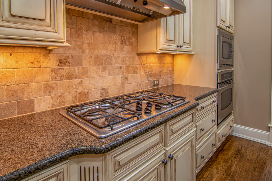 Elegant kitchen featuring granite countertops and stainless steel appliances. Photo by Curtis Adams on Pexels
