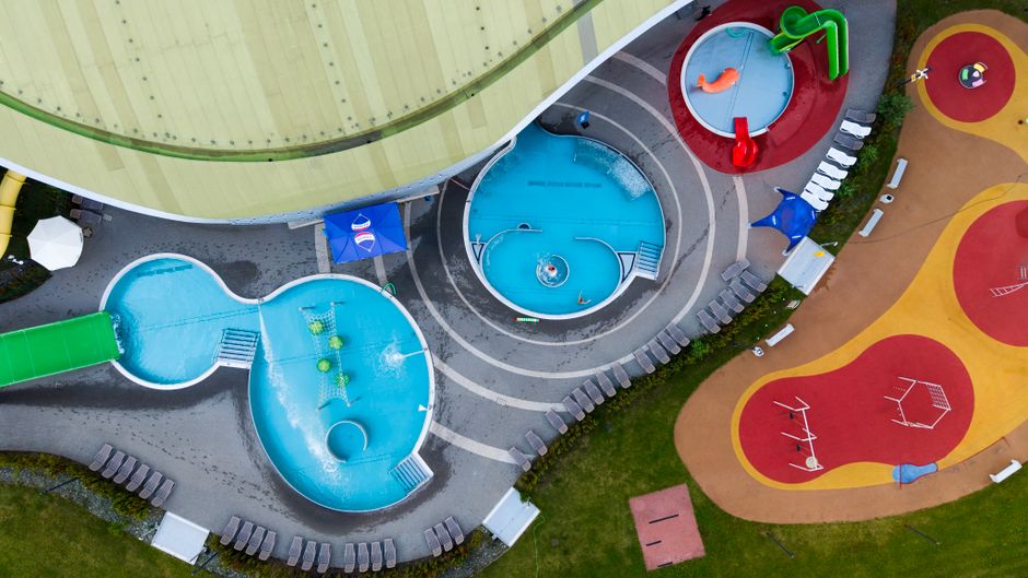 Photo by Anna Klinkosz on Pexels Vibrant aerial shot of a colorful outdoor water park with slides and pools. Photo by Anna Klinkosz on Pexels