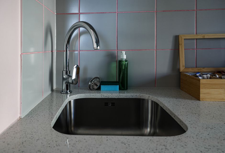 Stylish kitchen sink setup featuring chrome faucet, countertop, and accessories. Photo by Magda Ehlers on Pexels