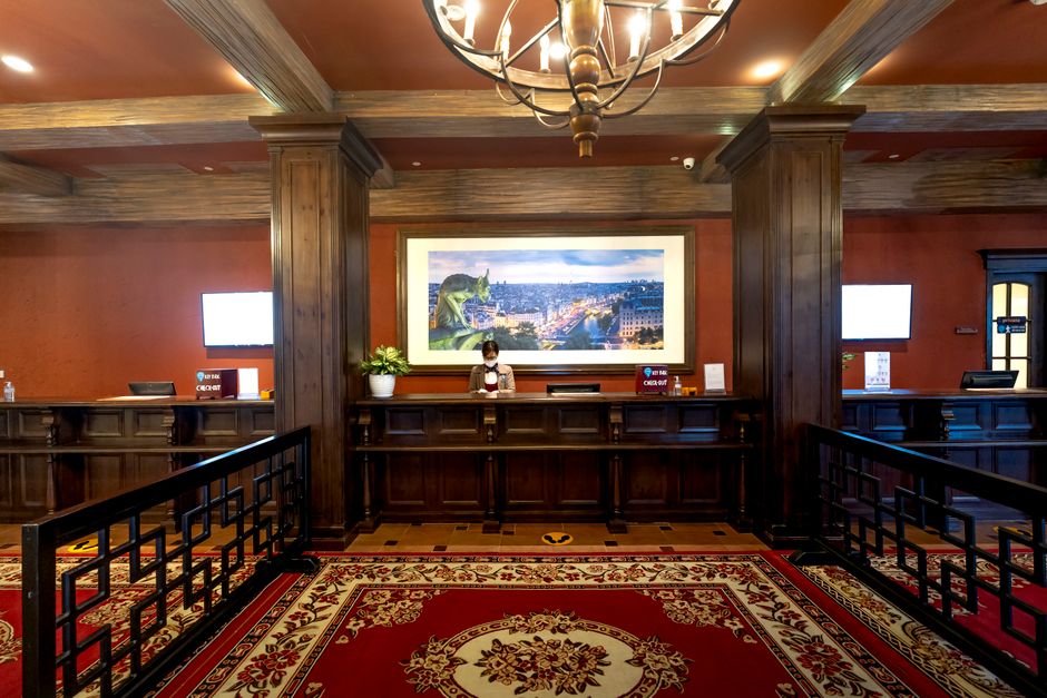 Elegant hotel lobby showcasing a receptionist at the front desk under warm lighting. Photo by Quang Nguyen Vinh on Pexels