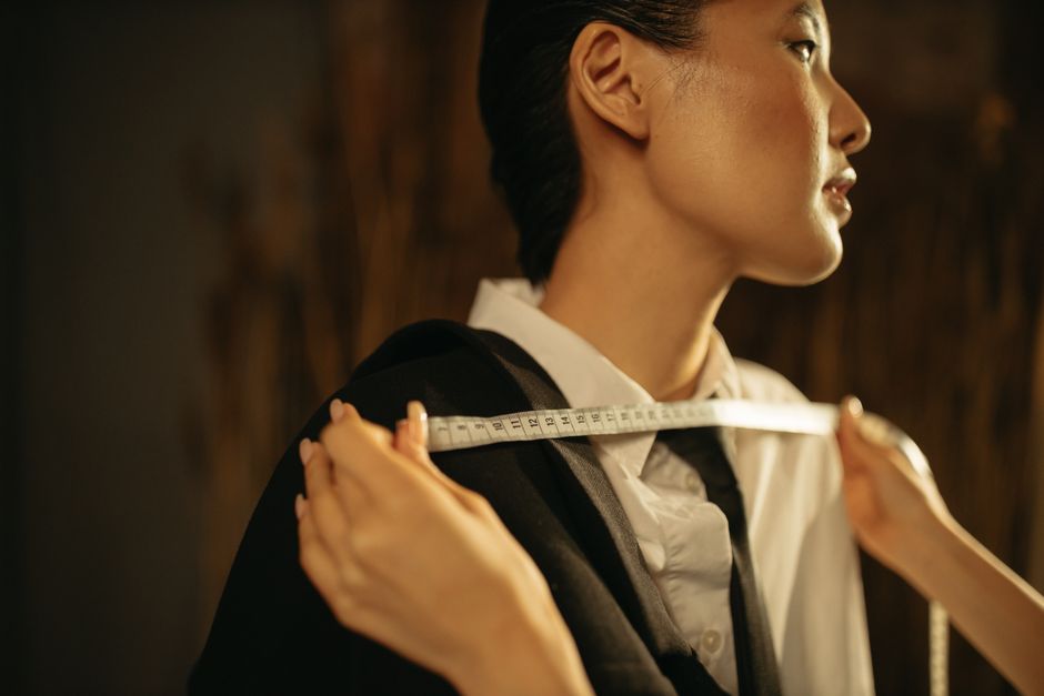 Photo by Yaroslav Shuraev on Pexels Close-up of an Asian woman in a vintage tailoring setup measuring a suit with precision. Photo by Yaroslav Shuraev on Pexels