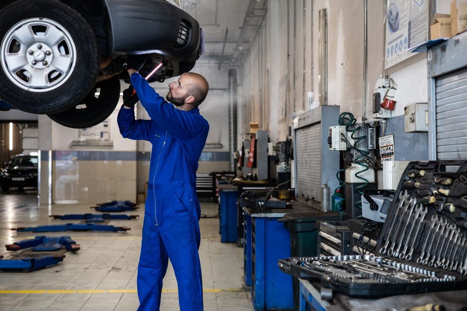 Photo by Artem Podrez on Pexels Mechanic working under a raised car in a tyre garage bay. Photo by Artem Podrez on Pexels
