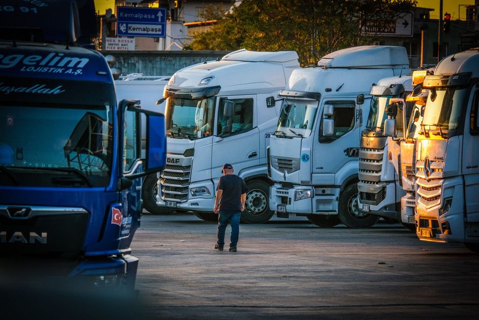 Photo by İsa kahraman on Pexels Fleet of trucks lined up in a depot with a man standing nearby. Photo by İsa kahraman on Pexels