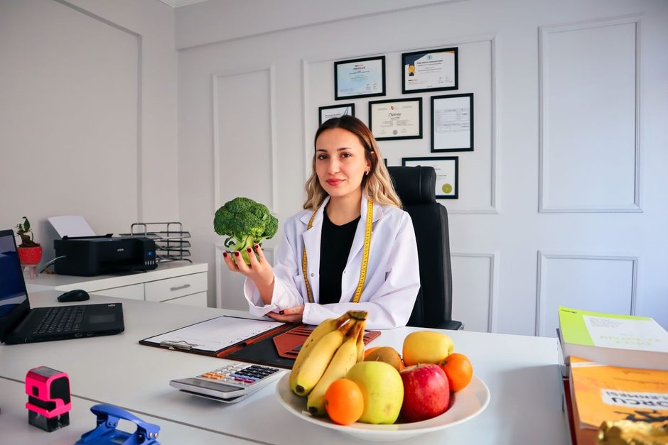 Photo by beyzahzah on Pexels Doctor consulting with a patient at a desk with a bowl of fruit. Photo by beyzahzah on Pexels