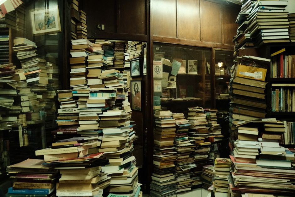 Photo by Beyzaa Yurtkuran on Pexels A cluttered, vintage bookshop with stacks of books and a warm ambiance. Photo by Beyzaa Yurtkuran on Pexels