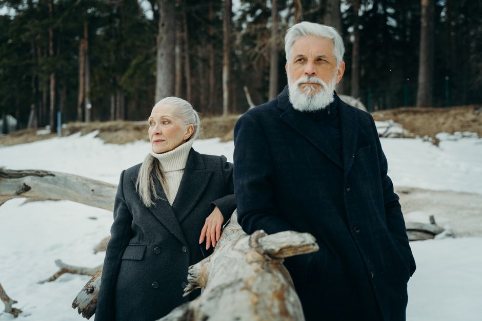 Photo by cottonbro studio on Pexels Senior couple wearing winter clothes leaning on tree log in snowy forest setting. Photo by cottonbro studio on Pexels