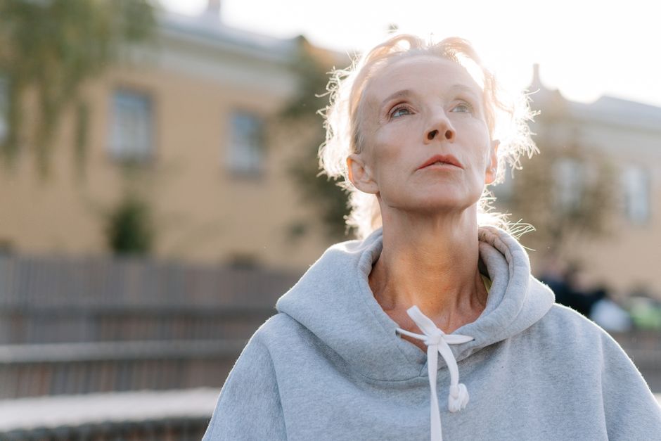 Photo by cottonbro studio on Pexels Senior woman in a hoodie looking upwards in an outdoor setting with a soft background. Photo by cottonbro studio on Pexels