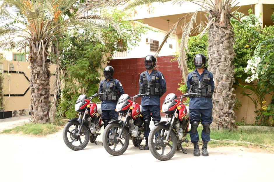 Photo by Malik Usman on Pexels Three security guards in uniform standing by motorbikes outdoors in a tropical setting. Photo by Malik Usman on Pexels