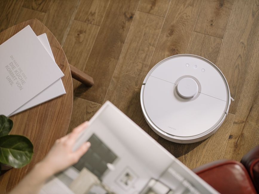 Photo by cottonbro studio on Pexels A sleek robot vacuum cleaner operating on a wooden floor, symbolizing modern home technology. Photo by cottonbro studio on Pexels