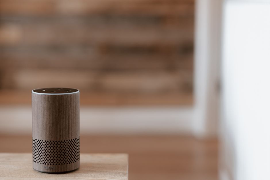 Photo by Anete Lusina on Pexels A stylish smart speaker sits on a wooden surface in a cozy, warm indoor setting. Photo by Anete Lusina on Pexels
