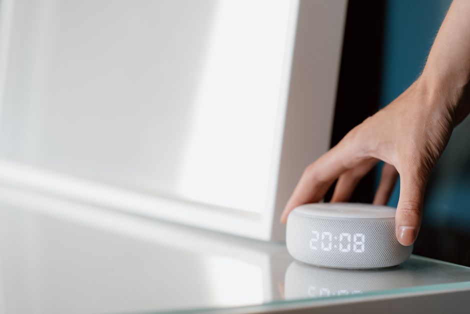 Photo by Anete Lusina on Pexels Close-up of a hand adjusting a smart speaker displaying time indoors. Photo by Anete Lusina on Pexels
