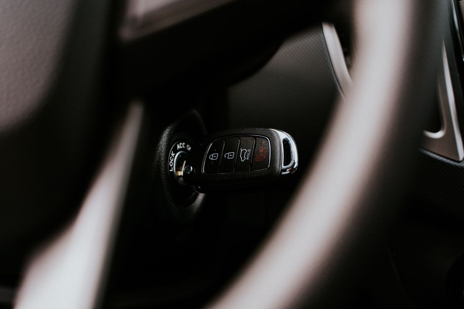 A close-up view of a car key placed in the ignition inside a vehicle, highlighting automotive detail. Photo by Daniel Andraski on Pexels