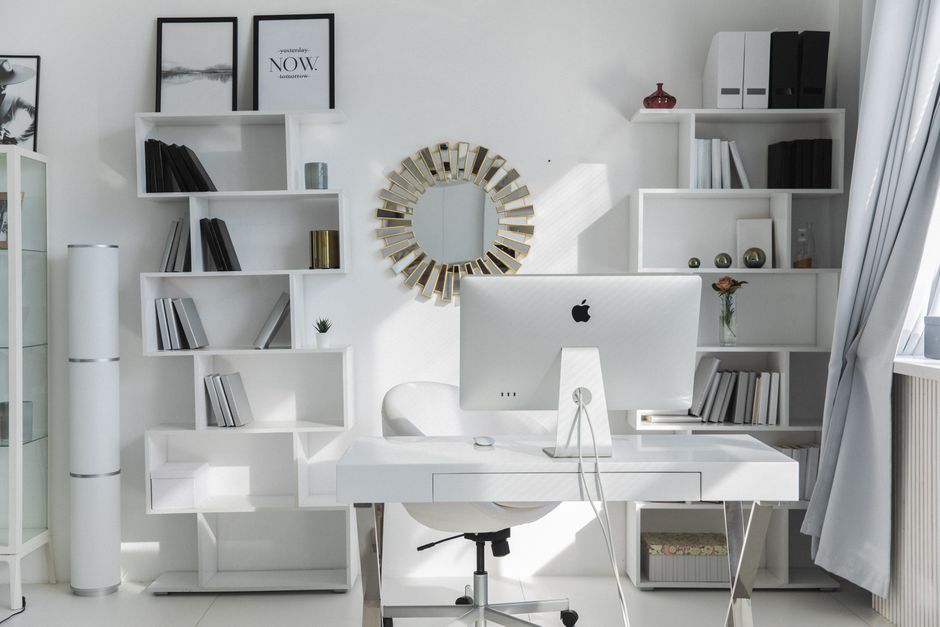 Bright minimalist home office setup with white shelves, desk, and iMac. Ideal for productivity. Photo by KATRIN  BOLOVTSOVA on Pexels