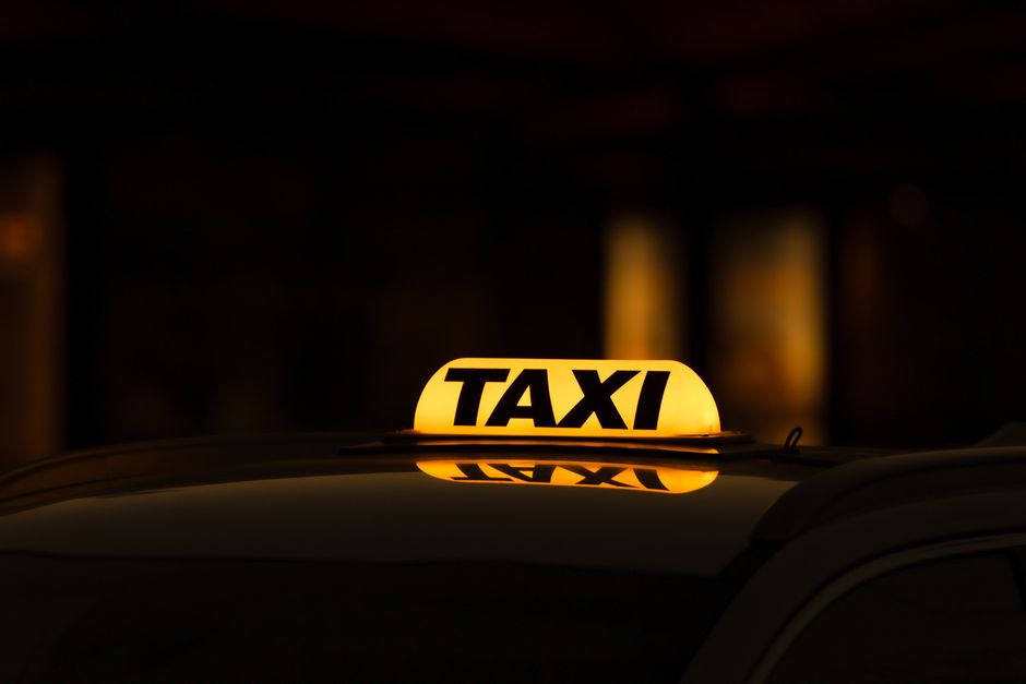 Yellow taxi sign glowing in Gothenburg night, perfect for urban travel themes. Photo by Efrem  Efre on Pexels