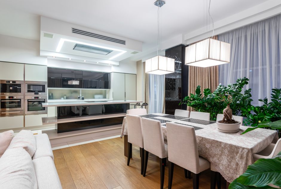 Photo by Max Vakhtbovych on Pexels Spacious dining room with large table and green potted plants placed near kitchen area in modern apartment. Photo by Max Vakhtbovych on Pexels