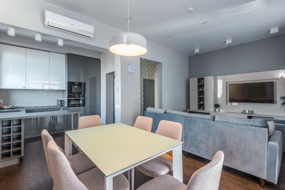 Photo by Max Vakhtbovych on Pexels Spacious open-plan living area with modern furnishings, featuring a dining table, sofa, and kitchen. Photo by Max Vakhtbovych on Pexels