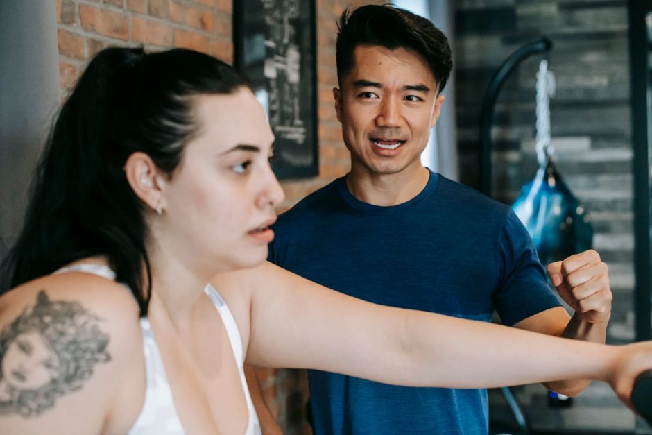 Photo by Andres Ayrton on Pexels Personal trainer coaching a client through a gym exercise. Photo by Andres Ayrton on Pexels