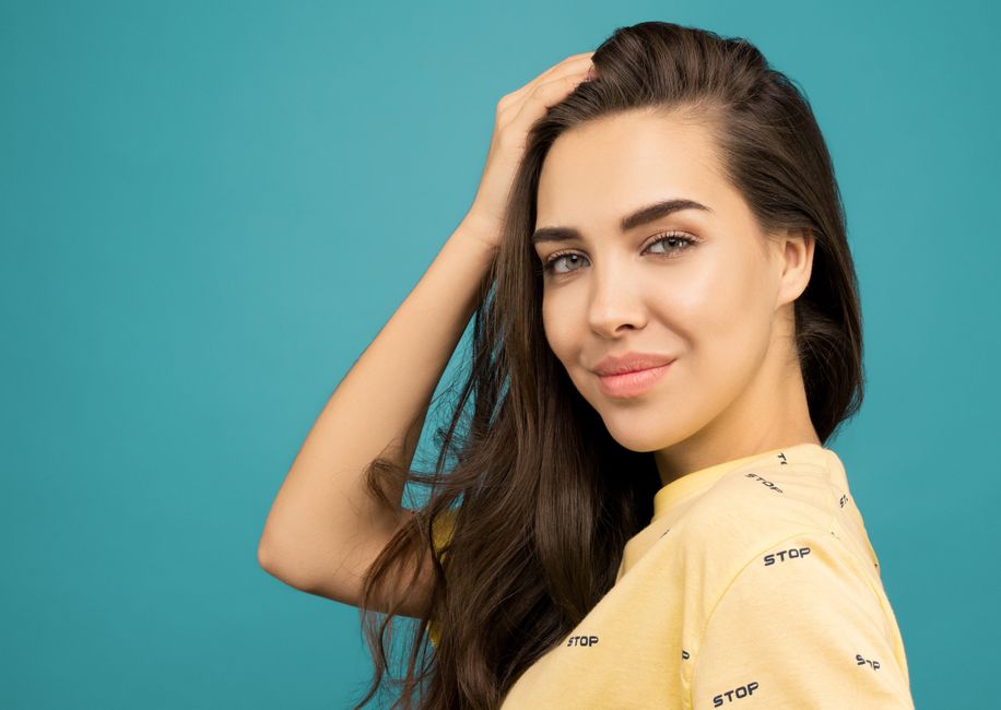 Photo by Sound On on Pexels Charming portrait of a smiling woman in casual attire against a blue background. Photo by Sound On on Pexels