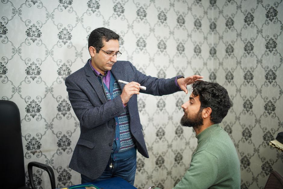 Photo by Imad Clicks on Pexels A doctor performs an eye examination on a patient in a clinical setting. Photo by Imad Clicks on Pexels