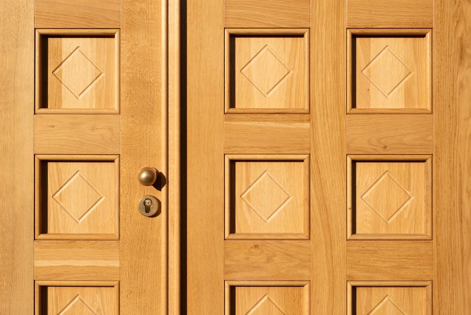 Photo by Jan van der Wolf on Pexels Close-up of a wooden door featuring geometric diamond patterns and a brass handle. Photo by Jan van der Wolf on Pexels