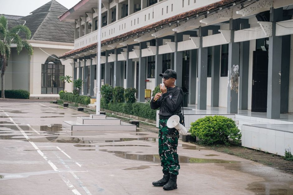 Photo by SMKN 1 GANTAR on Pexels Security guard in uniform patrolling outside a building with colonnaded facade. Photo by SMKN 1 GANTAR on Pexels