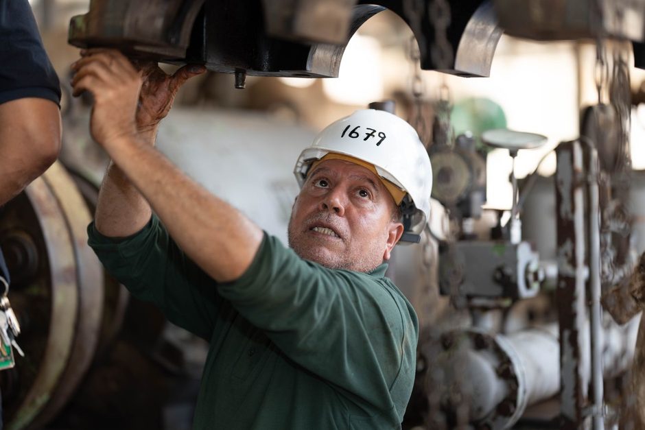 Photo by abdo alshreef on Pexels Technician in hard hat inspecting the underside of equipment in a utility space. Photo by abdo alshreef on Pexels