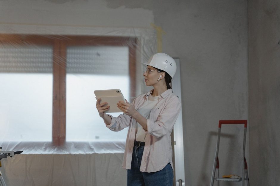 Photo by Tima Miroshnichenko on Pexels Inspector in a hard hat holding a clipboard assessing a building interior. Photo by Tima Miroshnichenko on Pexels
