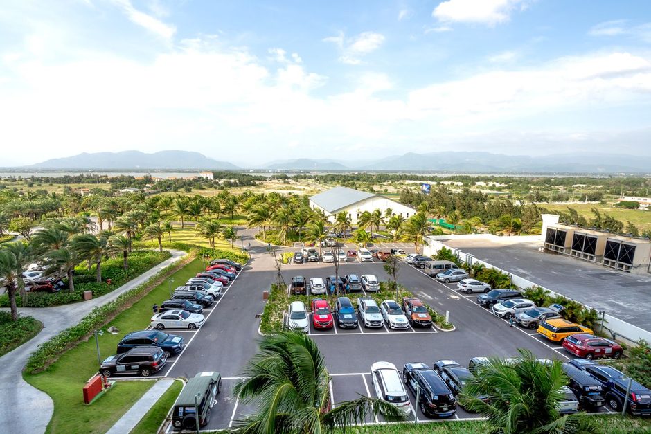 Aerial view of a large car park with rows of parked cars. Photo by Quang Nguyen Vinh on Pexels