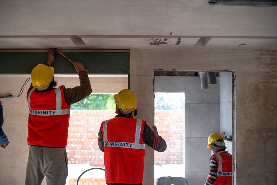 Photo by Infinity lifespaces on Pexels Two workers in hi-vis vests fitting a window opening in a building. Photo by Infinity lifespaces on Pexels