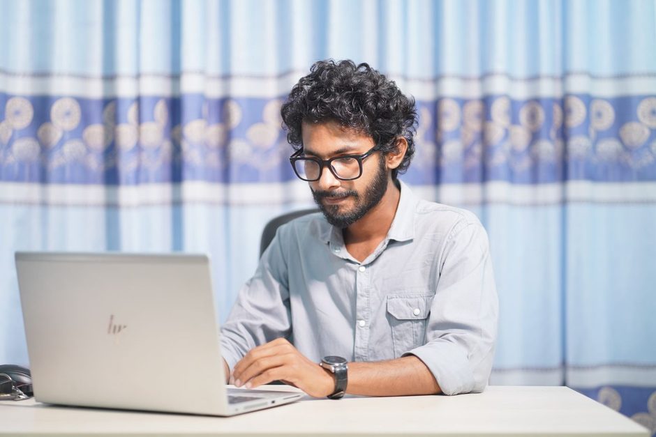 Photo by MASUD GAANWALA on Pexels Developer smiling at a laptop while reviewing page speed at a desk. Photo by MASUD GAANWALA on Pexels